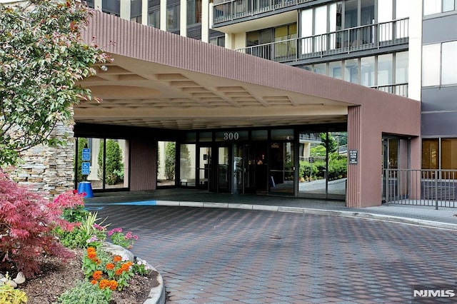 entrance to property featuring covered parking