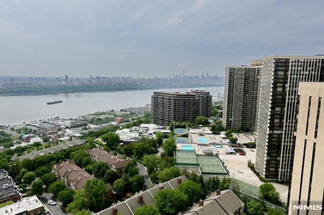 drone / aerial view with a city view and a water view