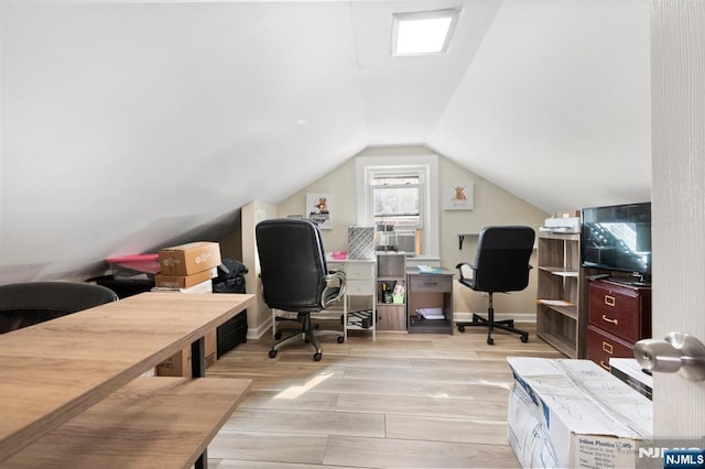 office area featuring lofted ceiling, wood finished floors, and baseboards