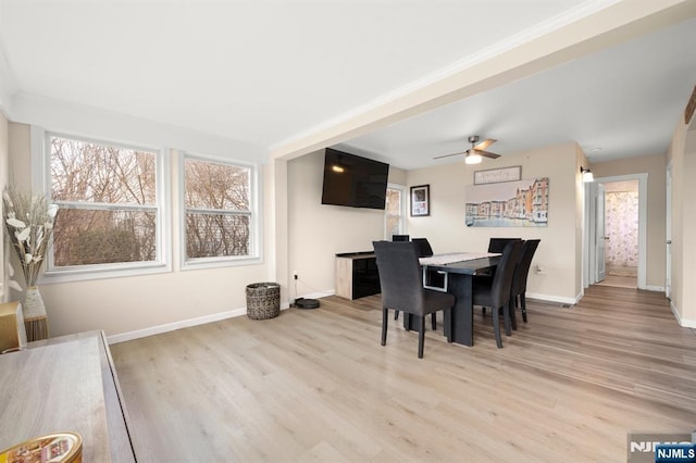 dining space featuring wood finished floors, baseboards, and ceiling fan