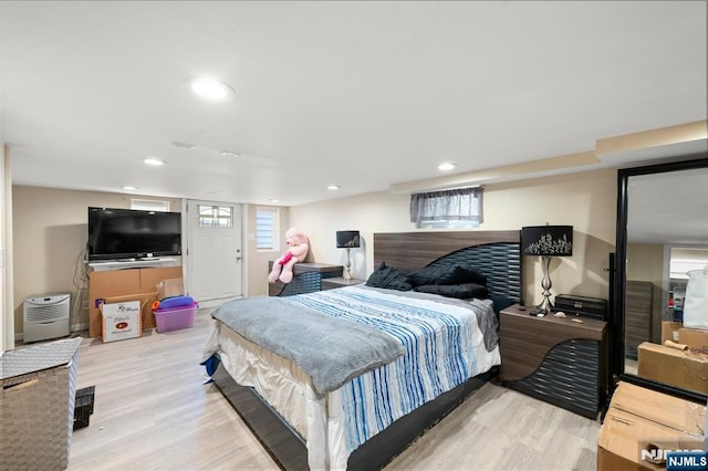 bedroom with recessed lighting and wood finished floors