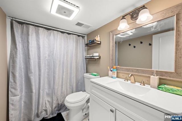 bathroom featuring vanity, toilet, a shower with curtain, and visible vents