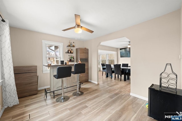 home office with baseboards and light wood-type flooring