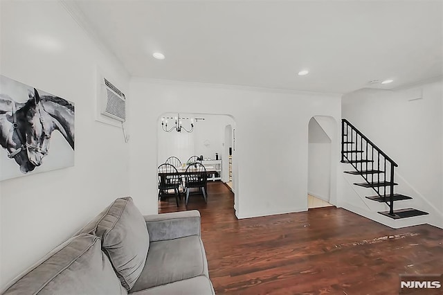 living area featuring stairway, wood finished floors, recessed lighting, arched walkways, and ornamental molding