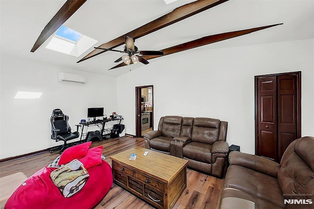 living room featuring lofted ceiling with skylight, light wood-style floors, a wall mounted air conditioner, and ceiling fan