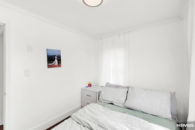 bedroom featuring baseboards and ornamental molding