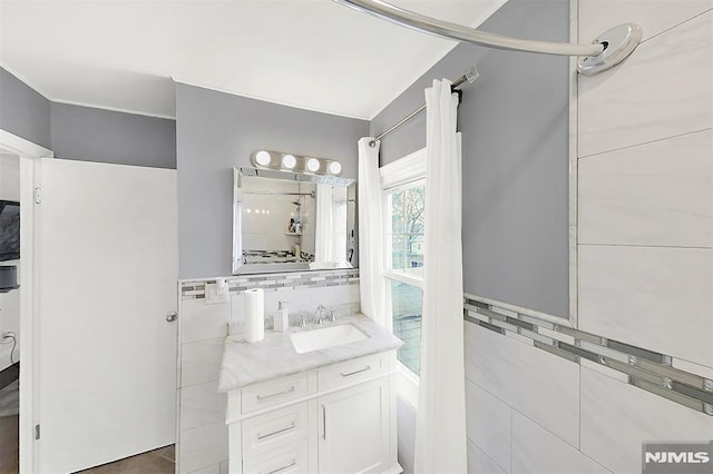 bathroom with tile walls and vanity