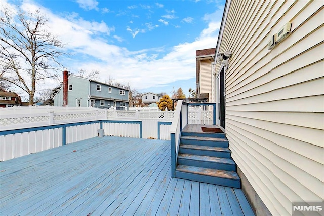 deck featuring fence and a residential view