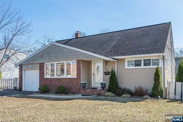 view of front of property with fence, a front yard, a garage, brick siding, and a chimney