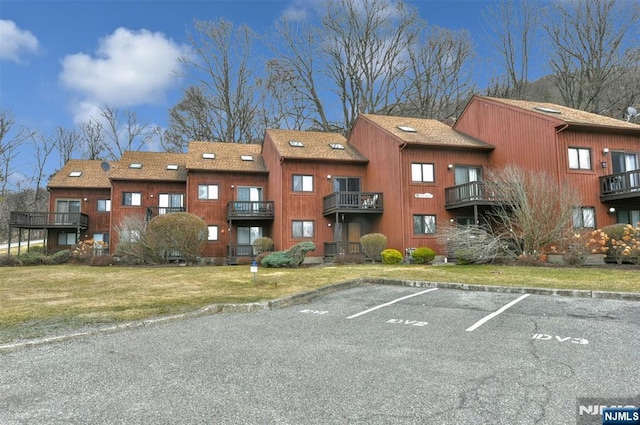 view of building exterior with uncovered parking