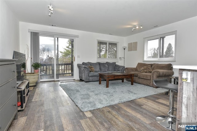 living room featuring visible vents, wood finished floors, and track lighting