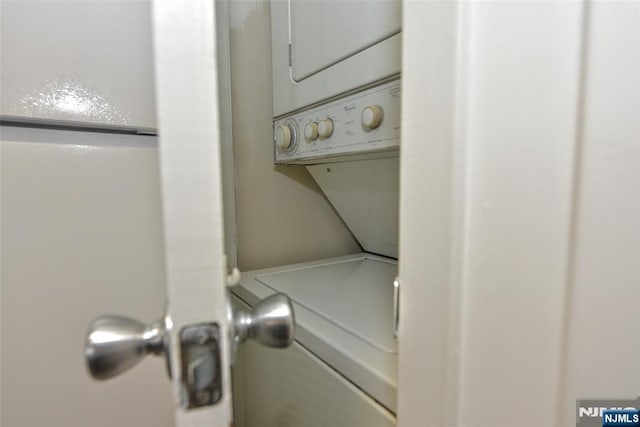 washroom with laundry area and stacked washing maching and dryer