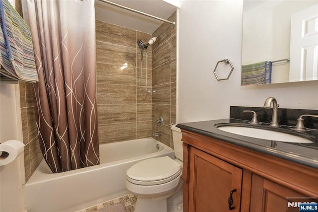 full bathroom featuring vanity, shower / bath combination with curtain, and toilet