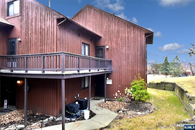 view of home's exterior featuring a yard and a deck