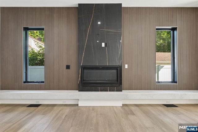 unfurnished living room featuring plenty of natural light and visible vents