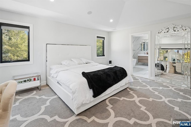 bedroom with ensuite bath, lofted ceiling, and recessed lighting