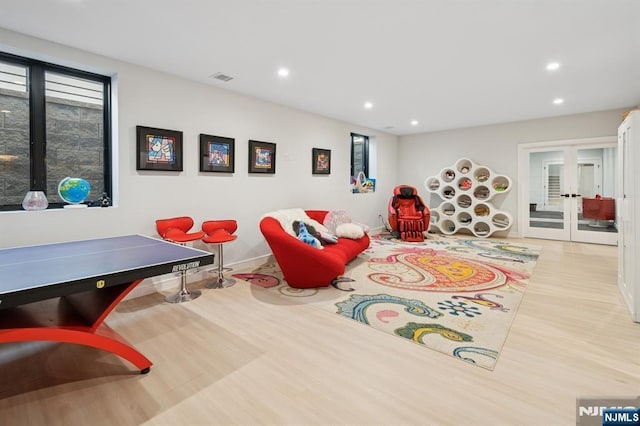 game room with visible vents, baseboards, recessed lighting, french doors, and wood finished floors