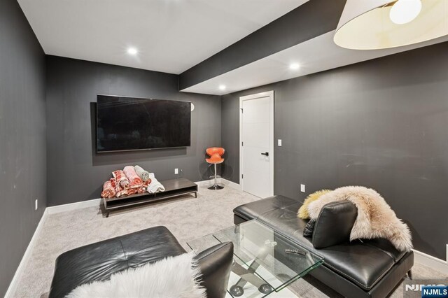 carpeted living area with recessed lighting and baseboards