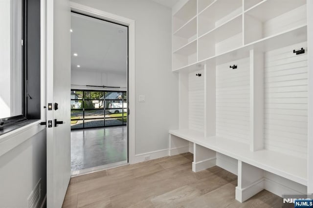 mudroom featuring baseboards and wood finished floors