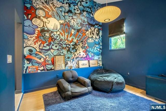 living area featuring wood finished floors and baseboards