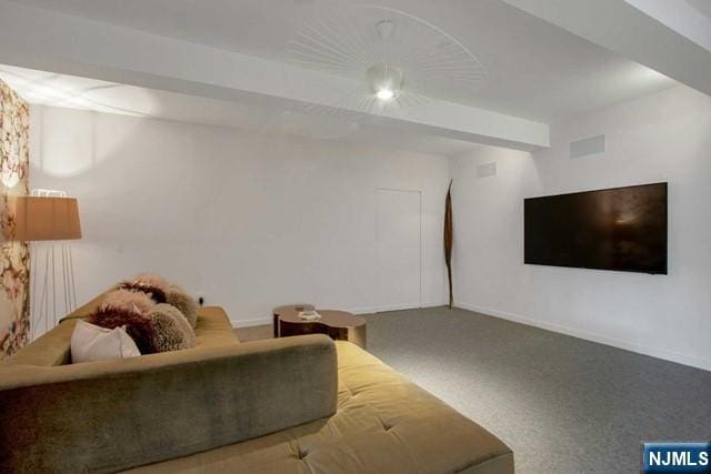 living area featuring beam ceiling, visible vents, baseboards, and carpet floors