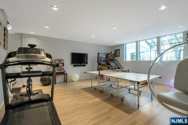 interior space with recessed lighting, wood finished floors, and baseboards