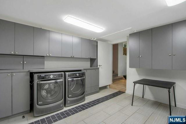 laundry room featuring cabinet space and independent washer and dryer