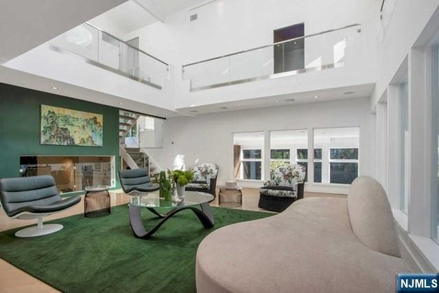 living room with stairs and a high ceiling