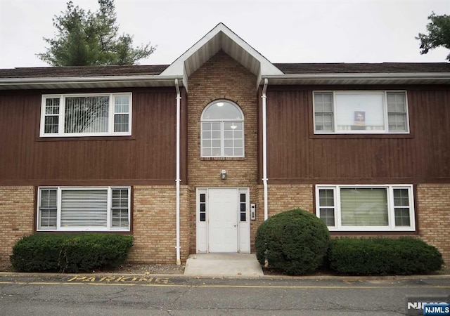 view of property with brick siding