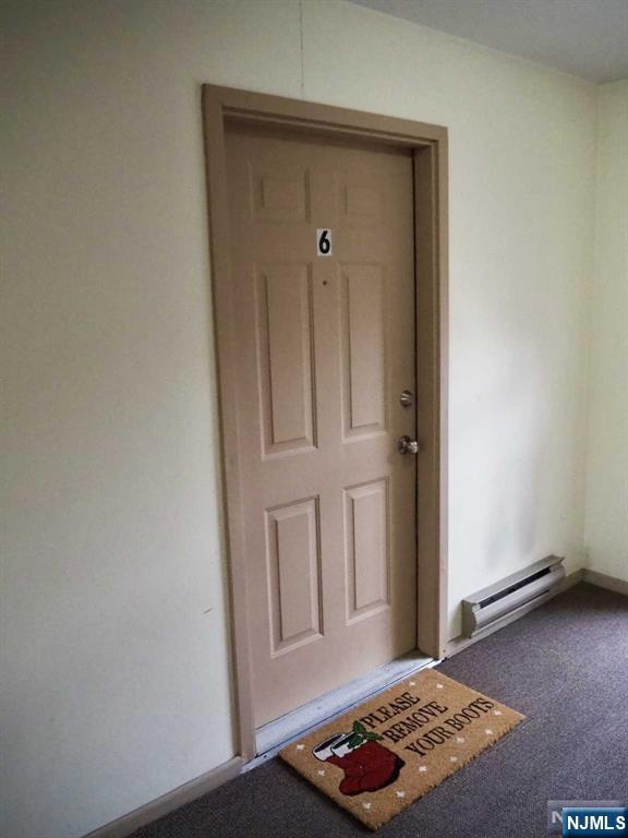 property entrance with a baseboard radiator