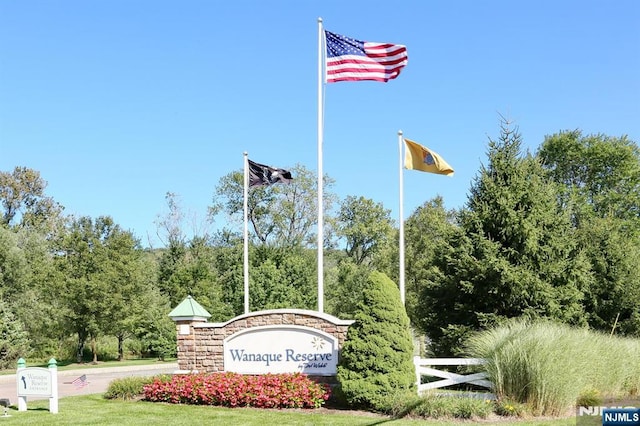 community sign featuring fence