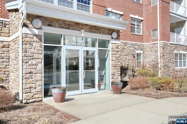 entrance to property with french doors and stone siding