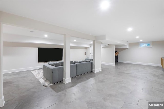 living area with a wall mounted air conditioner, baseboards, and recessed lighting