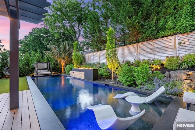 view of pool with a fenced backyard