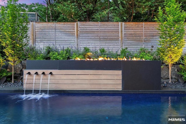 view of pool with a fenced backyard