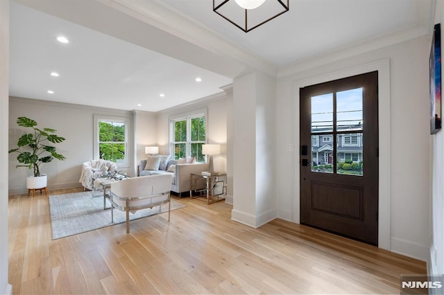 foyer entrance featuring recessed lighting, light wood-style flooring, baseboards, and ornamental molding