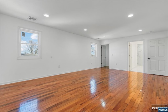 interior space featuring light wood-style flooring, recessed lighting, visible vents, and baseboards