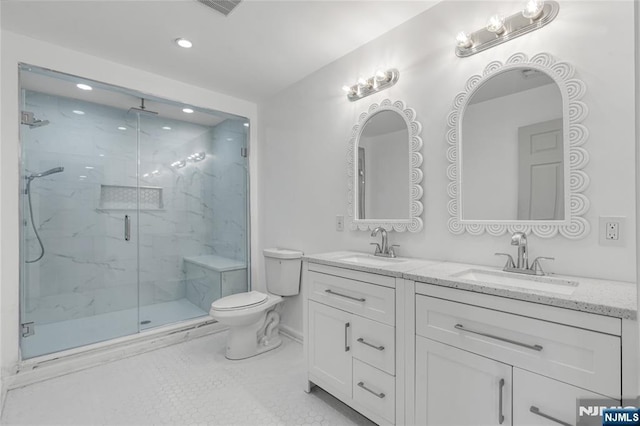 full bathroom with a sink, a marble finish shower, toilet, and double vanity