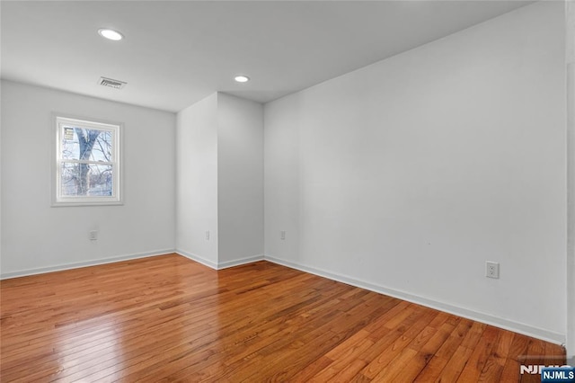 empty room with recessed lighting, visible vents, baseboards, and light wood-style floors