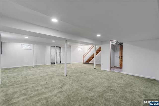 below grade area featuring stairway, recessed lighting, baseboards, and carpet