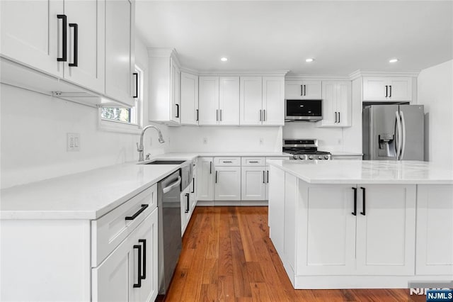 kitchen featuring a sink, light countertops, white cabinets, and stainless steel appliances