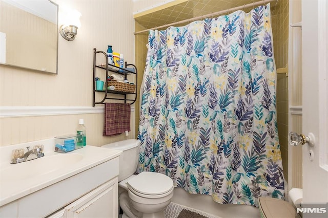 full bath with vanity, shower / tub combo, and toilet