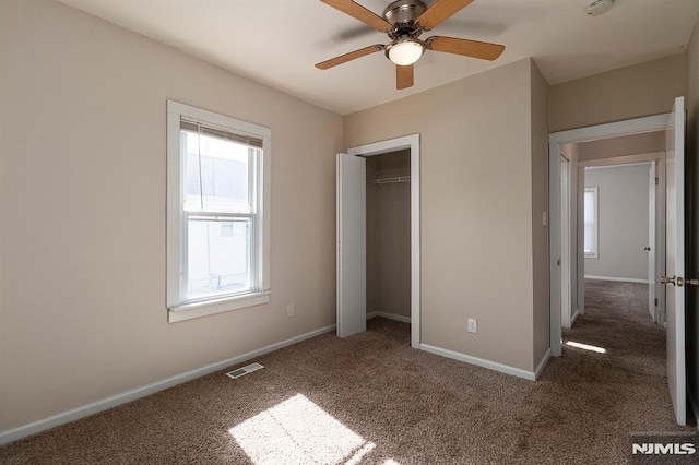 unfurnished bedroom featuring a closet, visible vents, baseboards, and carpet floors