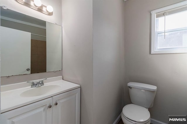 bathroom featuring toilet and vanity