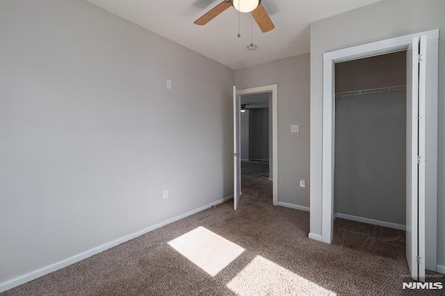 unfurnished bedroom featuring a closet, baseboards, ceiling fan, and carpet flooring