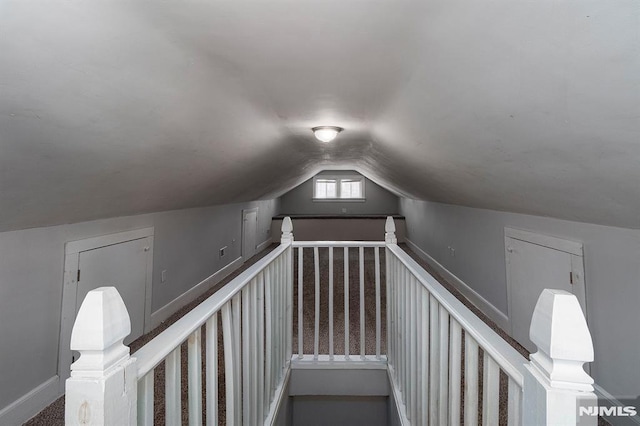 staircase with lofted ceiling