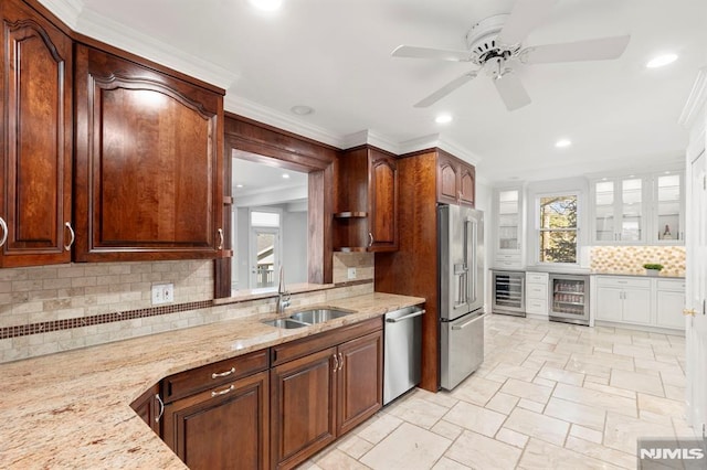 kitchen featuring a sink, beverage cooler, light stone countertops, and stainless steel appliances