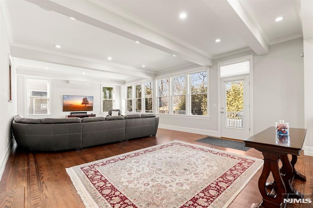 living area with crown molding, beamed ceiling, wood finished floors, and baseboards