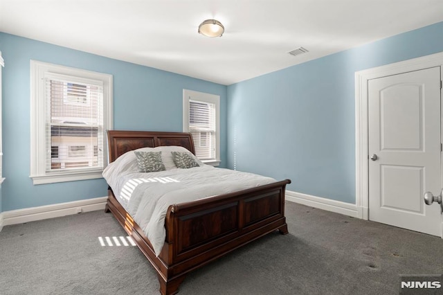 bedroom with visible vents, carpet flooring, baseboards, and multiple windows