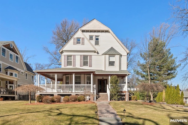 victorian house with a porch and a front yard